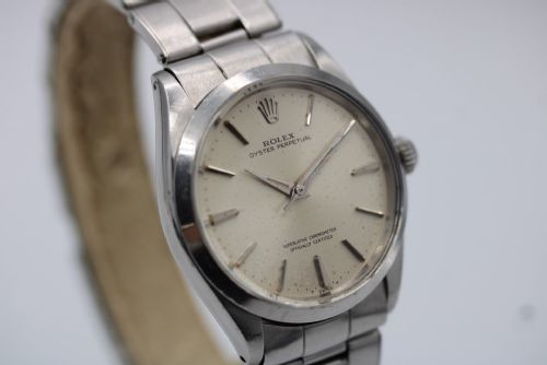 fig 2. A stainless steel Rolex Oyster Perpetual wrist watch featuring a silver dial with baton indices and an integrated steel bracelet.