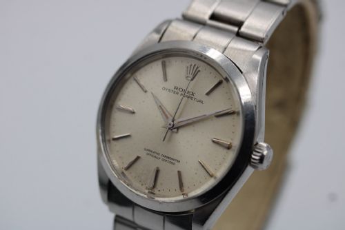 fig 3. A stainless steel Rolex Oyster Perpetual wrist watch featuring a silver dial with baton indices and an integrated steel bracelet.