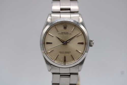 fig 5. A stainless steel Rolex Oyster Perpetual wrist watch featuring a silver dial with baton indices and an integrated steel bracelet.