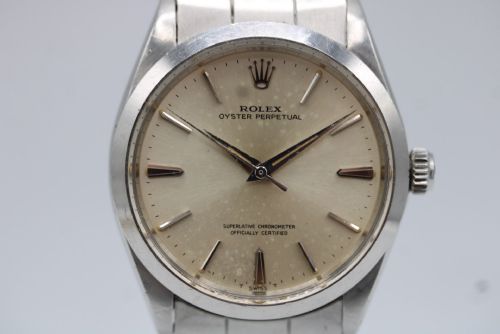 fig 6. A stainless steel Rolex Oyster Perpetual wrist watch featuring a silver dial with baton indices and an integrated steel bracelet.