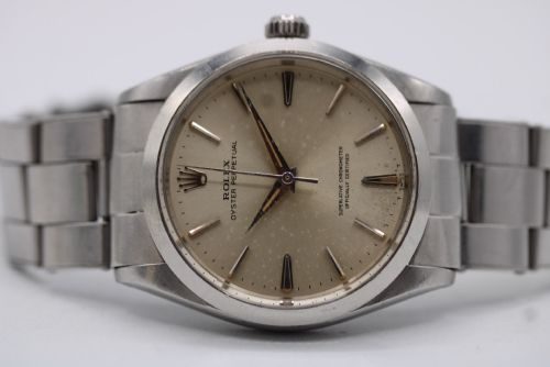 fig 7. A stainless steel Rolex Oyster Perpetual wrist watch featuring a silver dial with baton indices and an integrated steel bracelet.