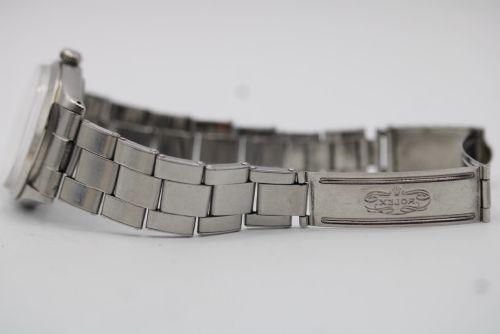 fig 8. A stainless steel Rolex Oyster Perpetual wrist watch featuring a silver dial with baton indices and an integrated steel bracelet.