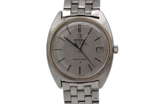 fig 1. A 1969 vintage Omega Constellation wristwatch featuring a stainless steel case, fluted bezel, silver linen dial, date window, and steel link bracelet.