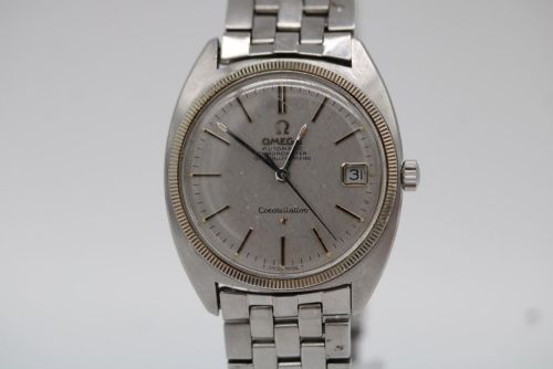 fig 3. A 1969 vintage Omega Constellation wristwatch featuring a stainless steel case, fluted bezel, silver linen dial, date window, and steel link bracelet.