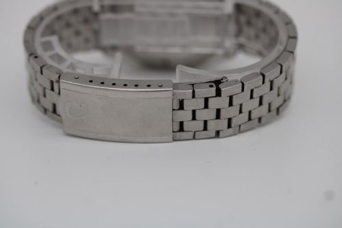 fig 6. A 1969 vintage Omega Constellation wristwatch featuring a stainless steel case, fluted bezel, silver linen dial, date window, and steel link bracelet.