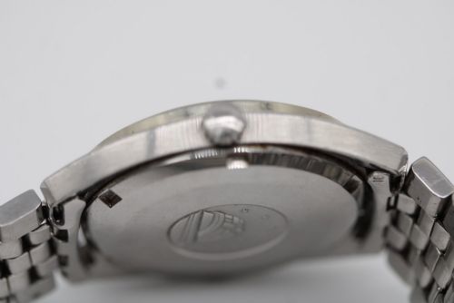 fig 7. A 1969 vintage Omega Constellation wristwatch featuring a stainless steel case, fluted bezel, silver linen dial, date window, and steel link bracelet.