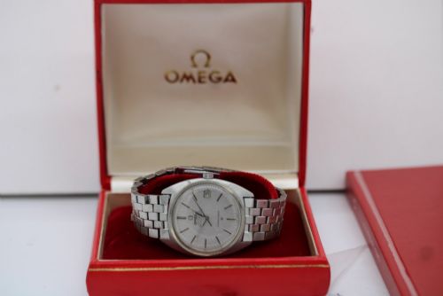 fig 8. A 1969 vintage Omega Constellation wristwatch featuring a stainless steel case, fluted bezel, silver linen dial, date window, and steel link bracelet.