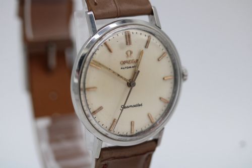 fig 4. A vintage 1961 Omega Seamaster wristwatch with a stainless steel case, silver dial, applied baton hour markers, and a tan leather strap.