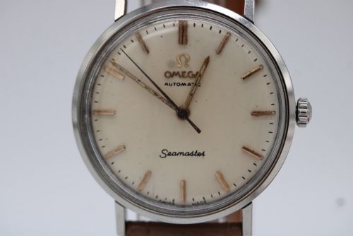 fig 6. A vintage 1961 Omega Seamaster wristwatch with a stainless steel case, silver dial, applied baton hour markers, and a tan leather strap.
