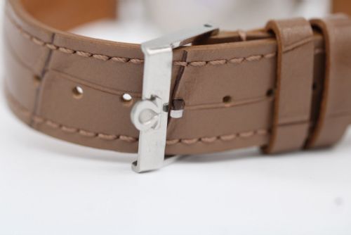 fig 7. A vintage 1961 Omega Seamaster wristwatch with a stainless steel case, silver dial, applied baton hour markers, and a tan leather strap.