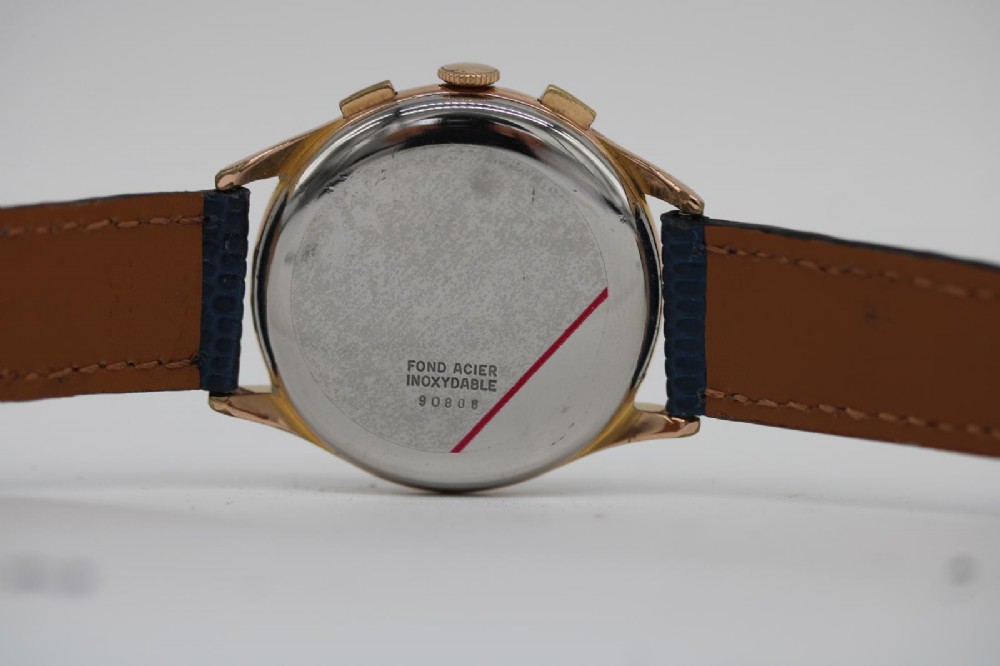 A 1963 stainless steel Omega Seamaster automatic wrist watch featuring a silver dial with baton indices, date window at three oclock, and a blue leather strap. View X