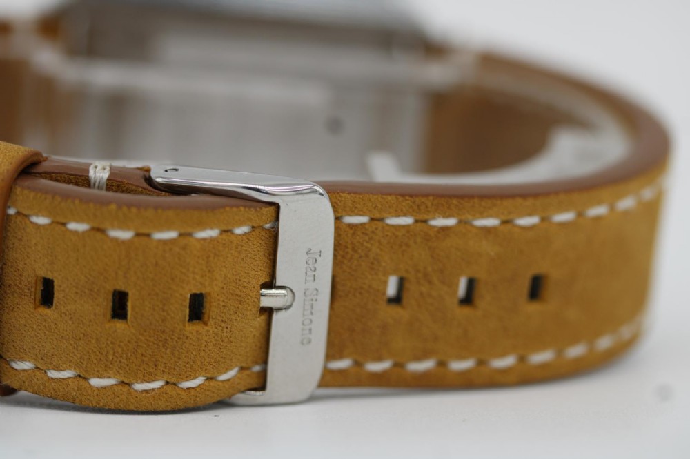 A vintage stainless steel Omega Seamaster Cosmic automatic wristwatch featuring a silver dial with day-date aperture and a tan leather strap with white stitching. View IV