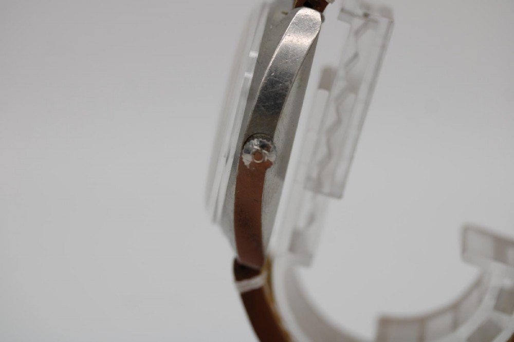 A vintage stainless steel Omega Seamaster Cosmic automatic wristwatch featuring a silver dial with day-date aperture and a tan leather strap with white stitching. View VIII