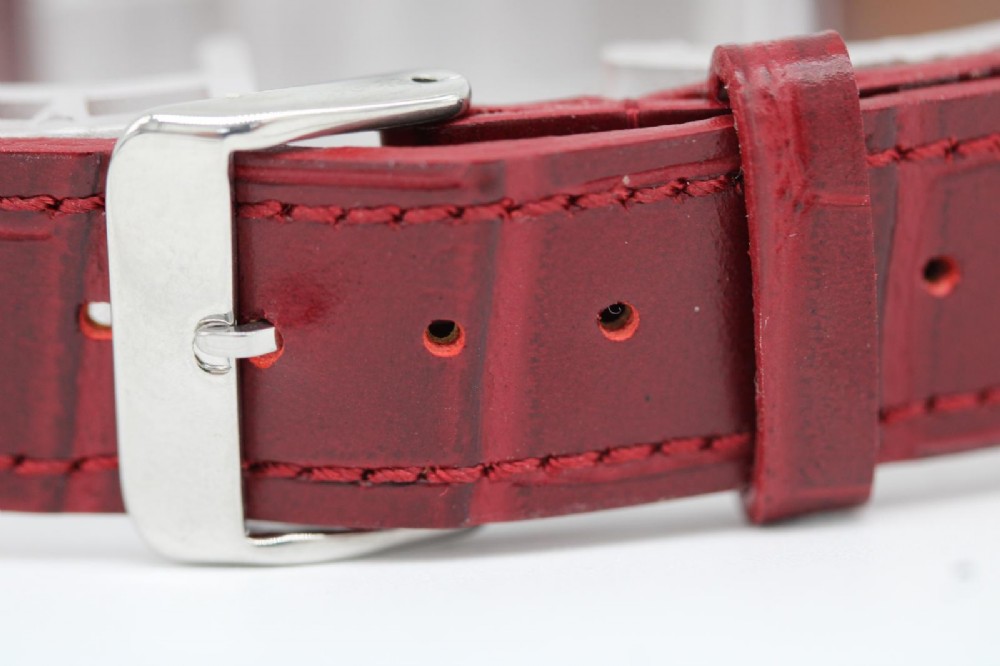 A 1950s Longines wristwatch with a stainless steel case, off-white dial with gold-tone hour markers, sub-seconds dial, and a burgundy leather strap. View II
