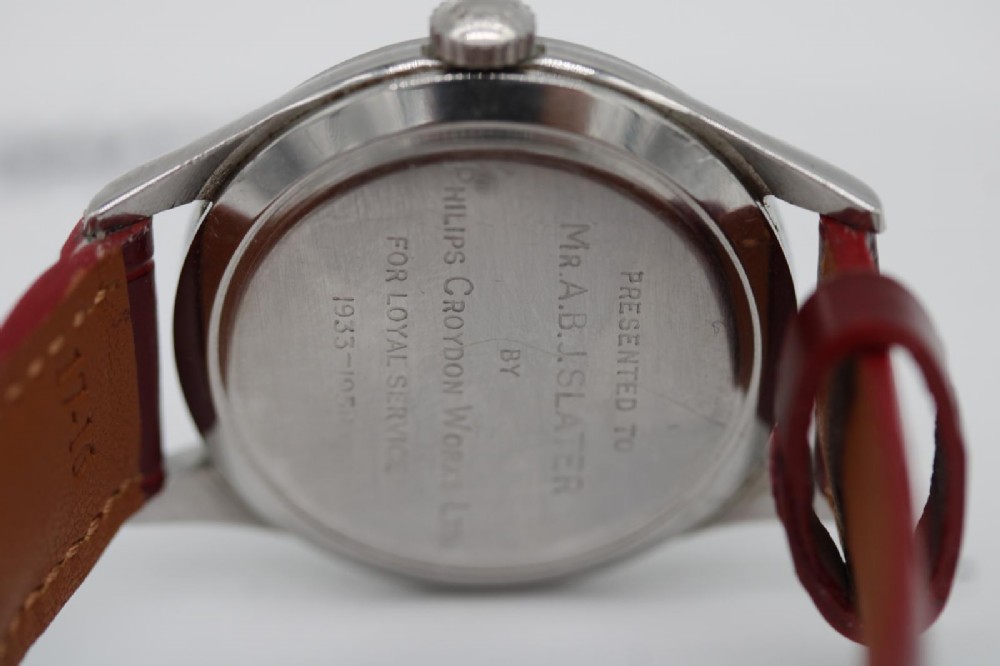 A 1950s Longines wristwatch with a stainless steel case, off-white dial with gold-tone hour markers, sub-seconds dial, and a burgundy leather strap. View VIII