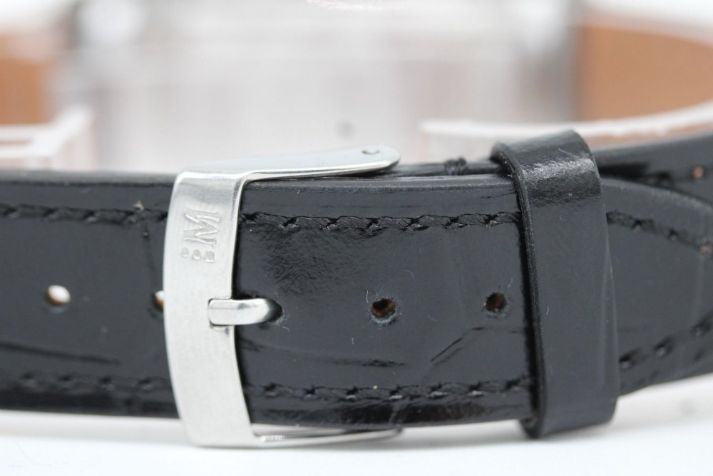 A 1960s Omega stainless steel manual-wind wristwatch featuring a silver dial with silver-toned Arabic numerals and indices on a black leather strap. View II