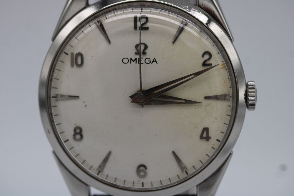 A 1960s Omega stainless steel manual-wind wristwatch featuring a silver dial with silver-toned Arabic numerals and indices on a black leather strap. View III