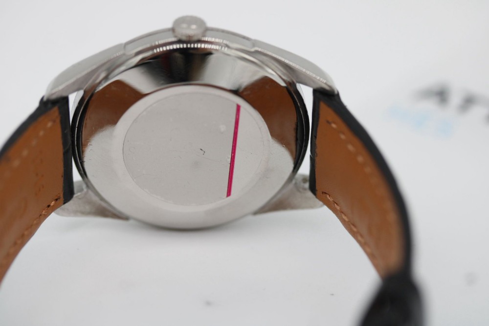 A 1960s Omega stainless steel manual-wind wristwatch featuring a silver dial with silver-toned Arabic numerals and indices on a black leather strap. View VIII