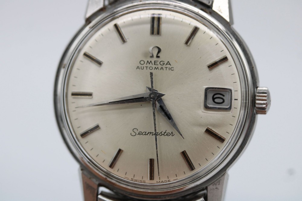 A vintage stainless steel Omega Seamaster automatic wristwatch with a silver dial and a beads-of-rice metal bracelet. View III