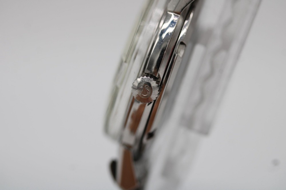 A vintage stainless steel Omega Seamaster automatic wristwatch with a silver dial and a beads-of-rice metal bracelet. View IV