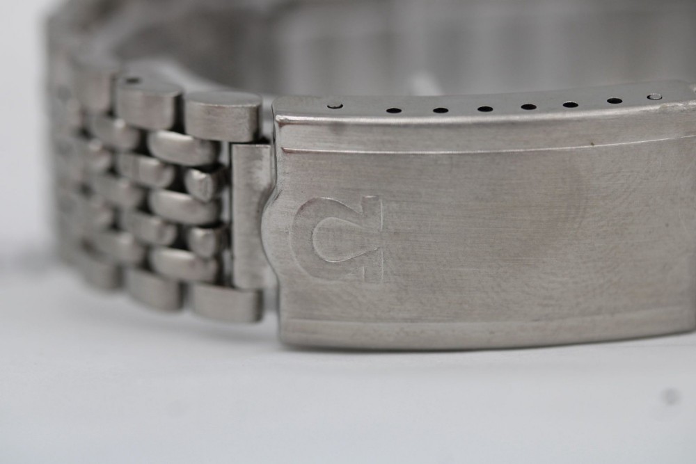 A vintage stainless steel Omega Seamaster automatic wristwatch with a silver dial and a beads-of-rice metal bracelet. View V