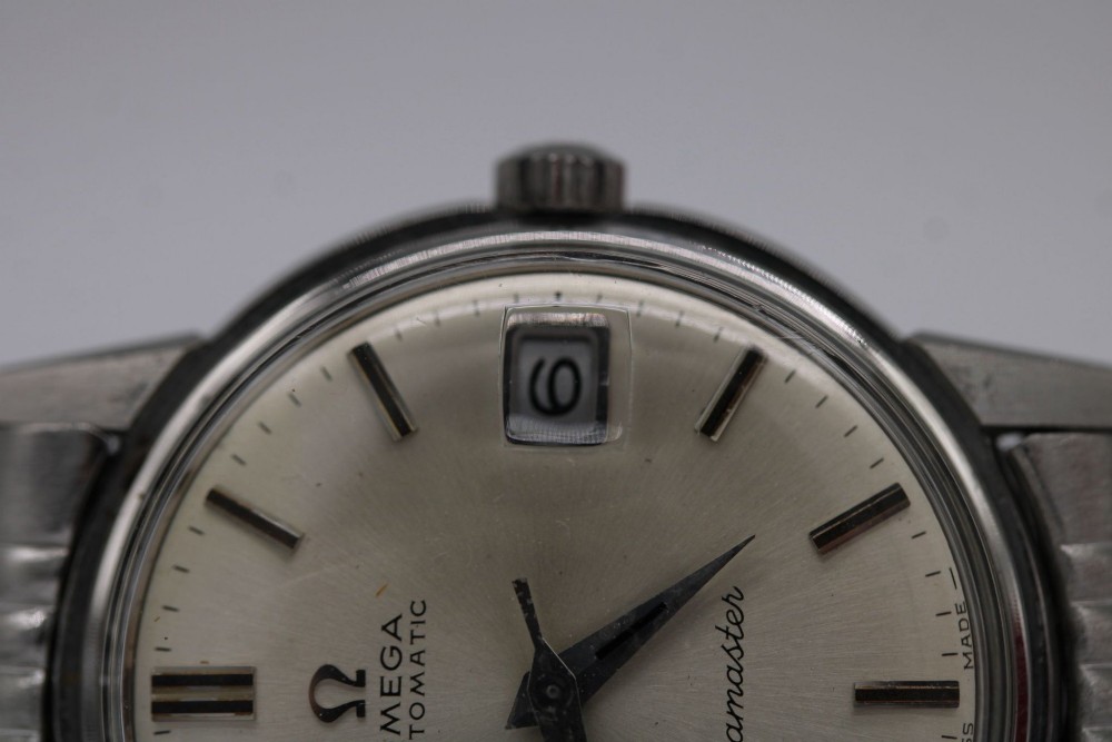 A vintage stainless steel Omega Seamaster automatic wristwatch with a silver dial and a beads-of-rice metal bracelet. View VII