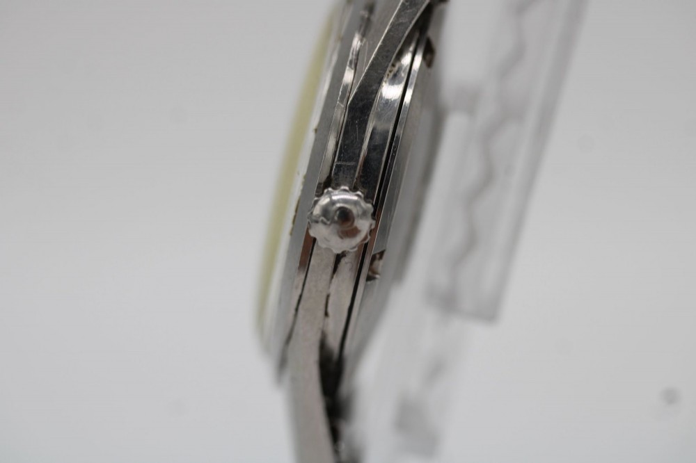 A 1960s stainless steel Omega Seamaster wristwatch with a patinated cream dial and a beads-of-rice bracelet. View II