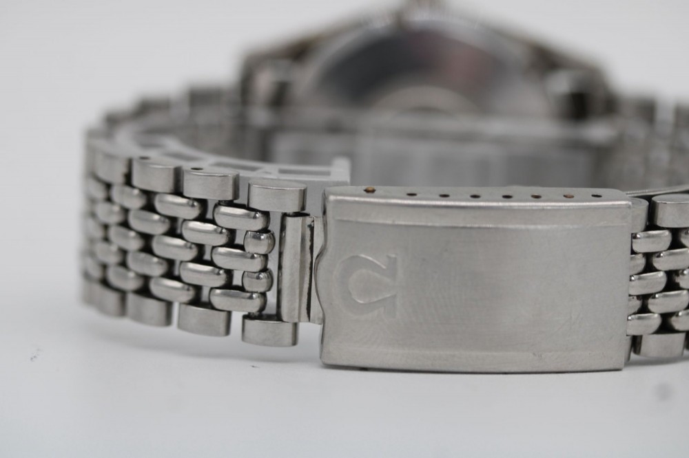 A 1960s stainless steel Omega Seamaster wristwatch with a patinated cream dial and a beads-of-rice bracelet. View III