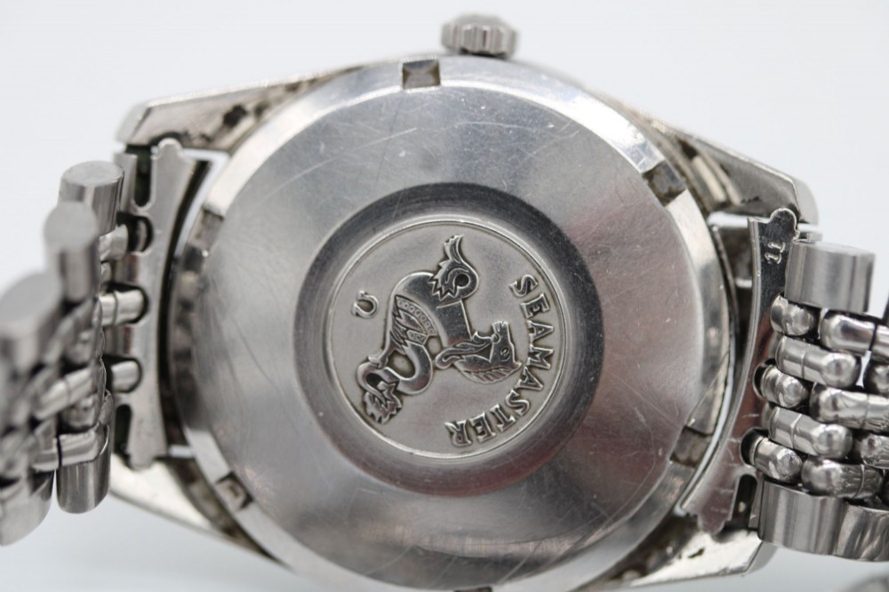A 1960s stainless steel Omega Seamaster wristwatch with a patinated cream dial and a beads-of-rice bracelet. View IV