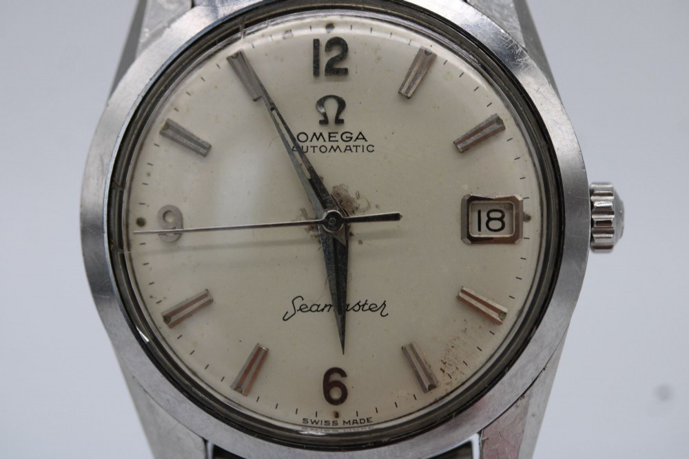 A 1960s stainless steel Omega Seamaster wristwatch with a patinated cream dial and a beads-of-rice bracelet. View IX