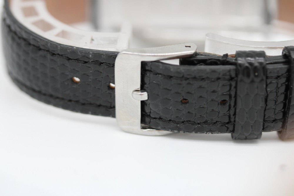 A round 1947 stainless steel Omega wristwatch displaying an aged cream dial with Arabic numerals and fitted with a black textured leather strap. View II