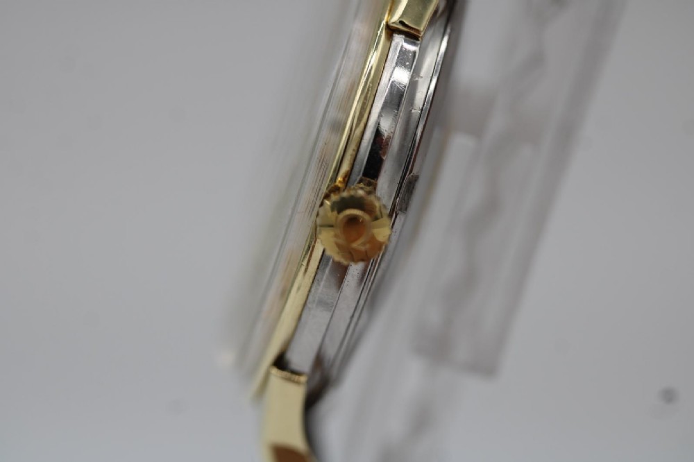A 1962 vintage Omega Constellation wristwatch featuring a gold pie-pan dial, date aperture, and brown leather strap. View VI