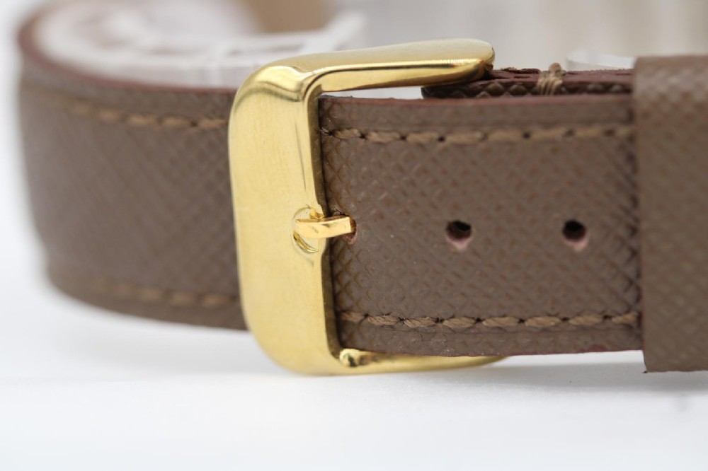 A 1962 vintage Omega Constellation wristwatch featuring a gold pie-pan dial, date aperture, and brown leather strap. View IX