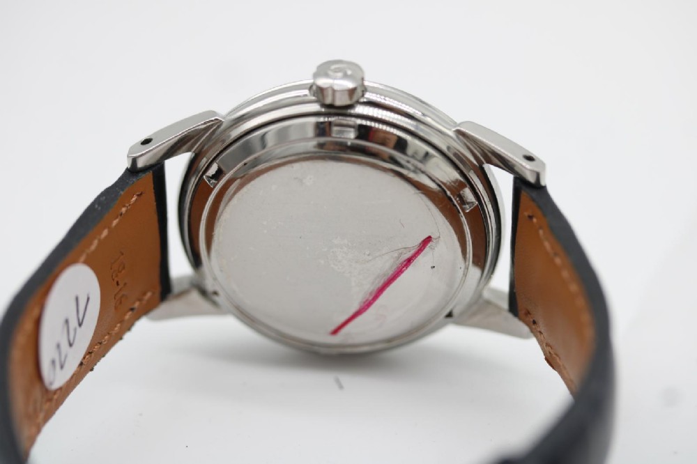 A vintage 1952 Omega Seamaster Calendar wristwatch featuring a stainless steel case, textured gold-coloured dial with date display at six oclock, and a black leather strap. View X
