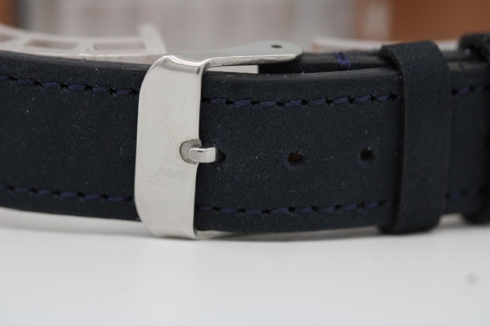 A 1950s stainless steel Omega Seamaster wristwatch featuring a patinated cream dial with silver baton indices and a black leather strap. View V