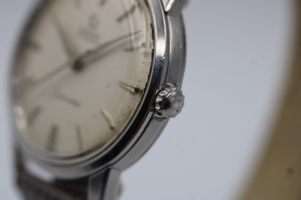 A vintage 1960 Omega Seamaster automatic wristwatch with a stainless steel case, silver cream dial, and grey textured leather strap. View V