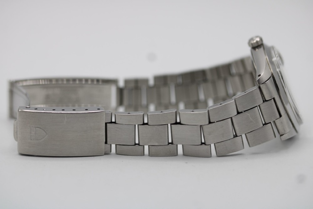 A stainless steel Rolex Oyster Perpetual wrist watch featuring a silver dial with baton indices and an integrated steel bracelet. View X