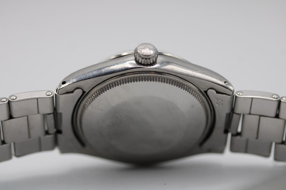 A stainless steel Rolex Oyster Perpetual wrist watch featuring a silver dial with baton indices and an integrated steel bracelet. View XIII
