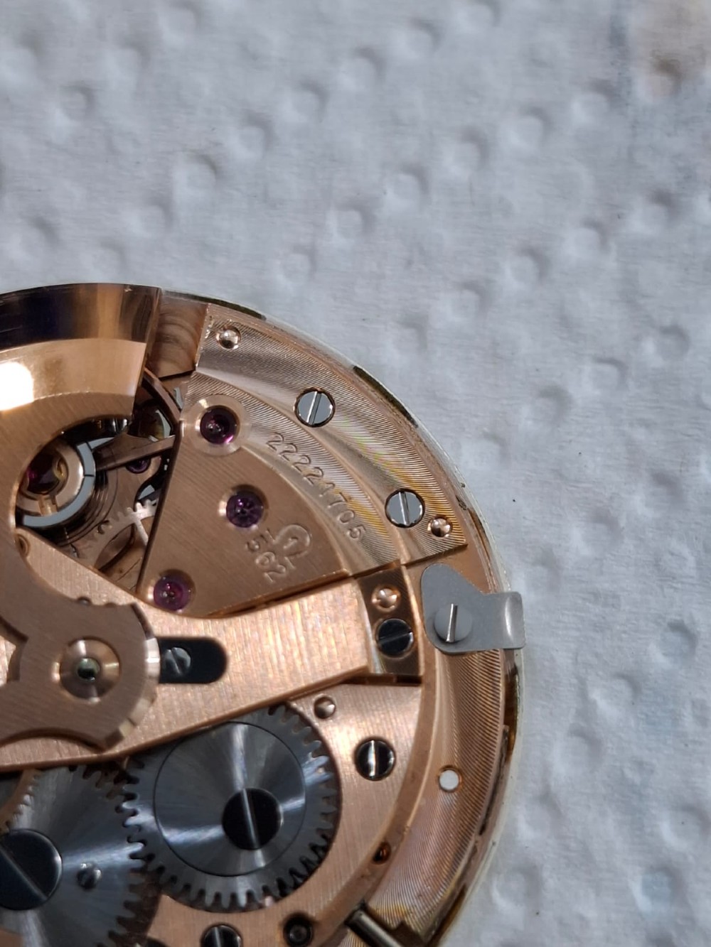 A vintage gold-plated Omega Seamaster DeVille automatic wristwatch with a white textured dial, gold baton indices, date window, and black leather strap. View XIII