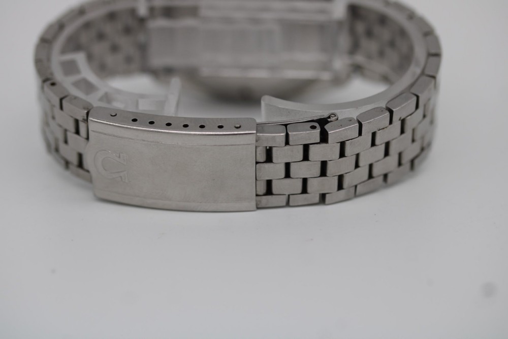 A 1969 vintage Omega Constellation wristwatch featuring a stainless steel case, fluted bezel, silver linen dial, date window, and steel link bracelet. View VII