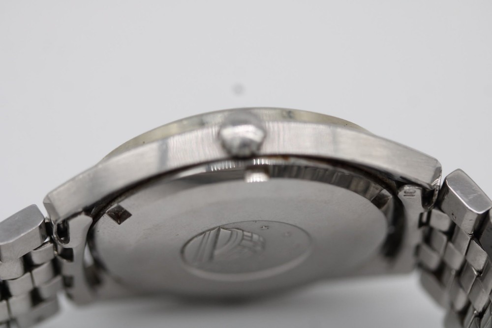 A 1969 vintage Omega Constellation wristwatch featuring a stainless steel case, fluted bezel, silver linen dial, date window, and steel link bracelet. View VIII