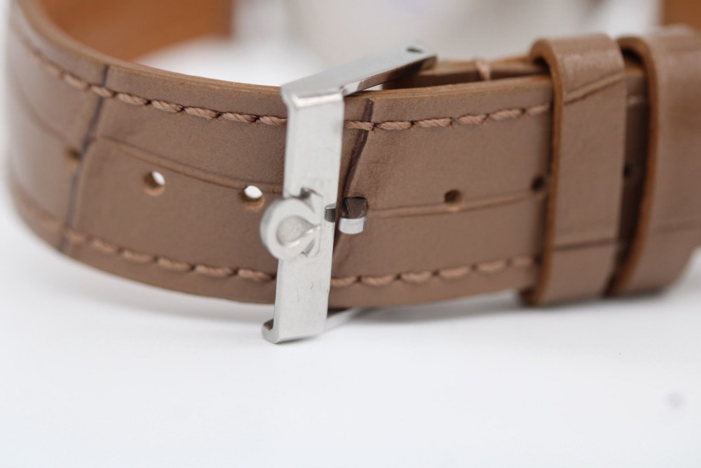A vintage 1961 Omega Seamaster wristwatch with a stainless steel case, silver dial, applied baton hour markers, and a tan leather strap. View VIII