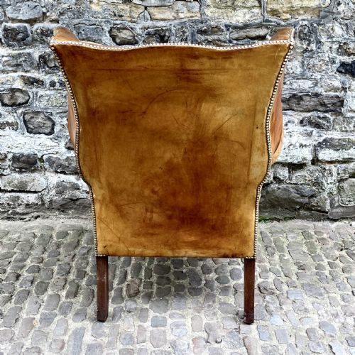 A LATE VICTORIAN LEATHER WING ARMCHAIR - ADDITIONAL PHOTO 1