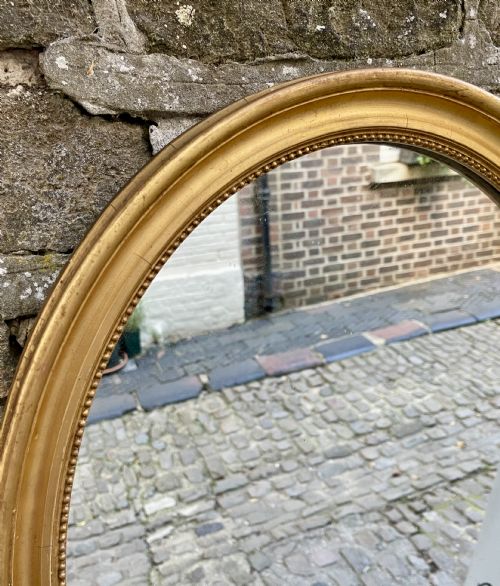 A MID VICTORIAN OVAL GILTWOOD MIRROR - ADDITIONAL PHOTO 2