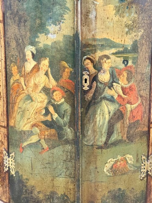 fig 1. An eighteenth-century George II bowfront corner cupboard featuring two curved doors painted with a green pastoral scene and fitted with pierced brass hinges.