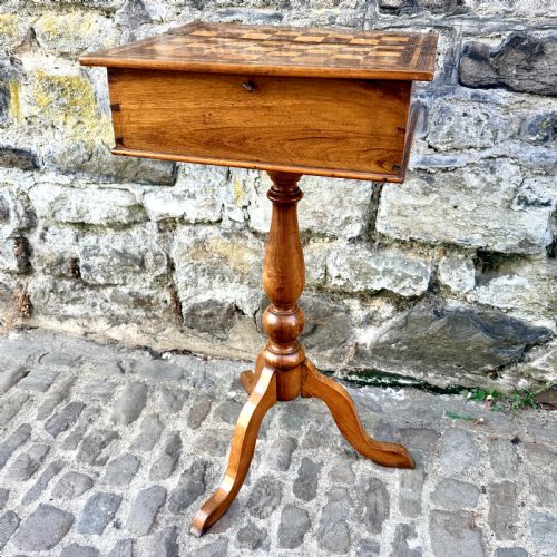 fig 1. An early nineteenth-century French Provincial wooden chess table featuring an inlaid chessboard top, a turned pedestal support, and a tripod cabriole base.