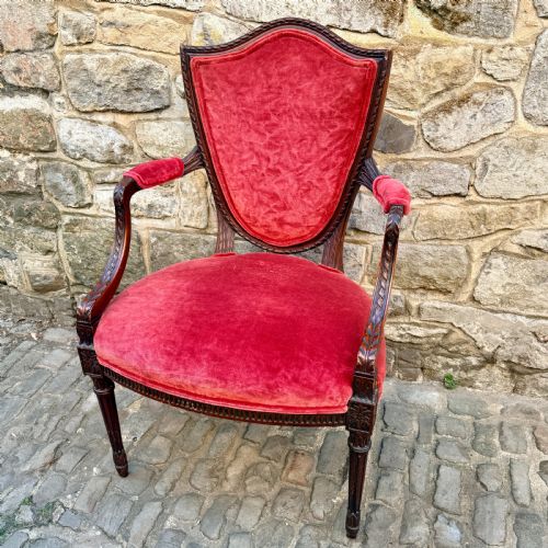 fig 1. A Sheraton Revival mahogany desk chair with red velvet upholstery, a shield back, and fluted front legs.