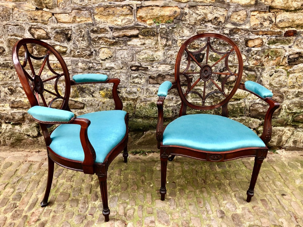 Pair of Sheraton Revival mahogany elbow chairs with oval wheel-back splats, carved rosettes, turquoise velvet seats, and turned reeded front legs. View III