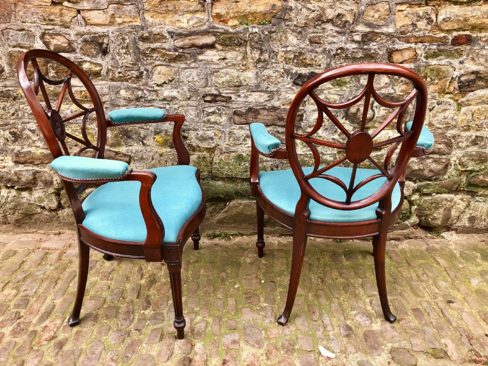 Pair of Sheraton Revival mahogany elbow chairs with oval wheel-back splats, carved rosettes, turquoise velvet seats, and turned reeded front legs. View IV