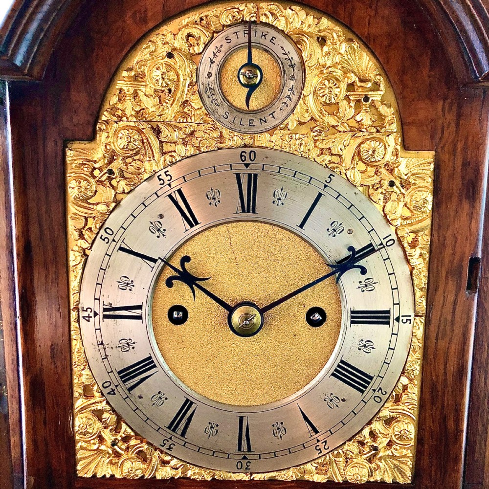 A late 19th-century mahogany bracket clock featuring an arched silvered dial, gilt-bronze caryatid mounts, and a brass finial top. View III
